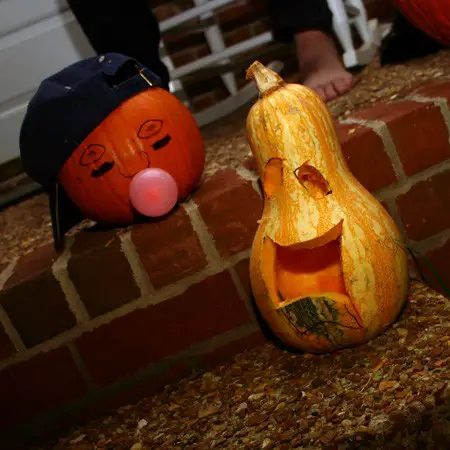 Pumpkin carvings of our baseball player blowing bubbles and a happy gourd.