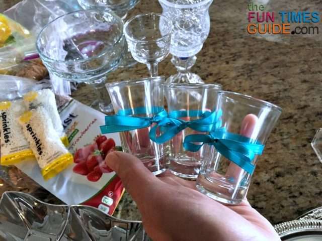 These small glass jars with ribbons tied around them were used to hold some of the DIY cupcake toppings.