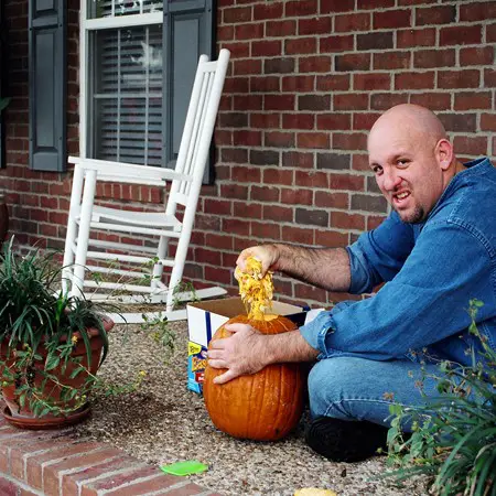 Jim pulling the guts out of a pumpkin before carving.