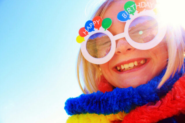 The birthday girl wearing Happy Birthday glasses and a big Happy Birthday smile!