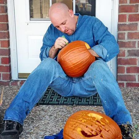 Jim carving his pumpkin.