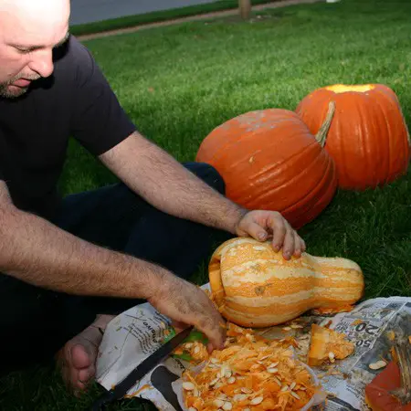 Jim getting into the Halloween spirit cleaning out all the pumpkin guts & gourd guts.