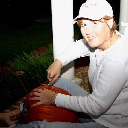 Lynnette carving one of our big orange pumpkins in 2004.
