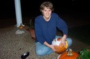 Lynnette using a template to carve a pumpkin.