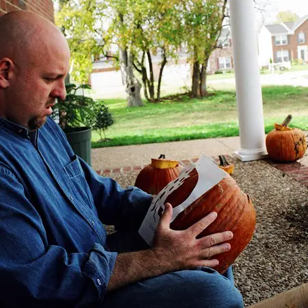 Jim placing the template on his pumpkin.