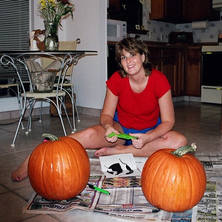 Lynnette using all the right to carve pumpkins.